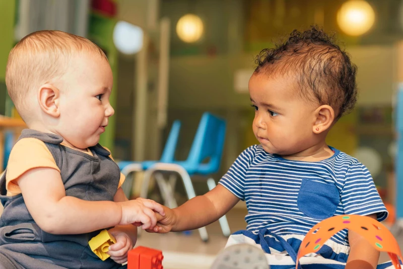 Infant playing with a toy